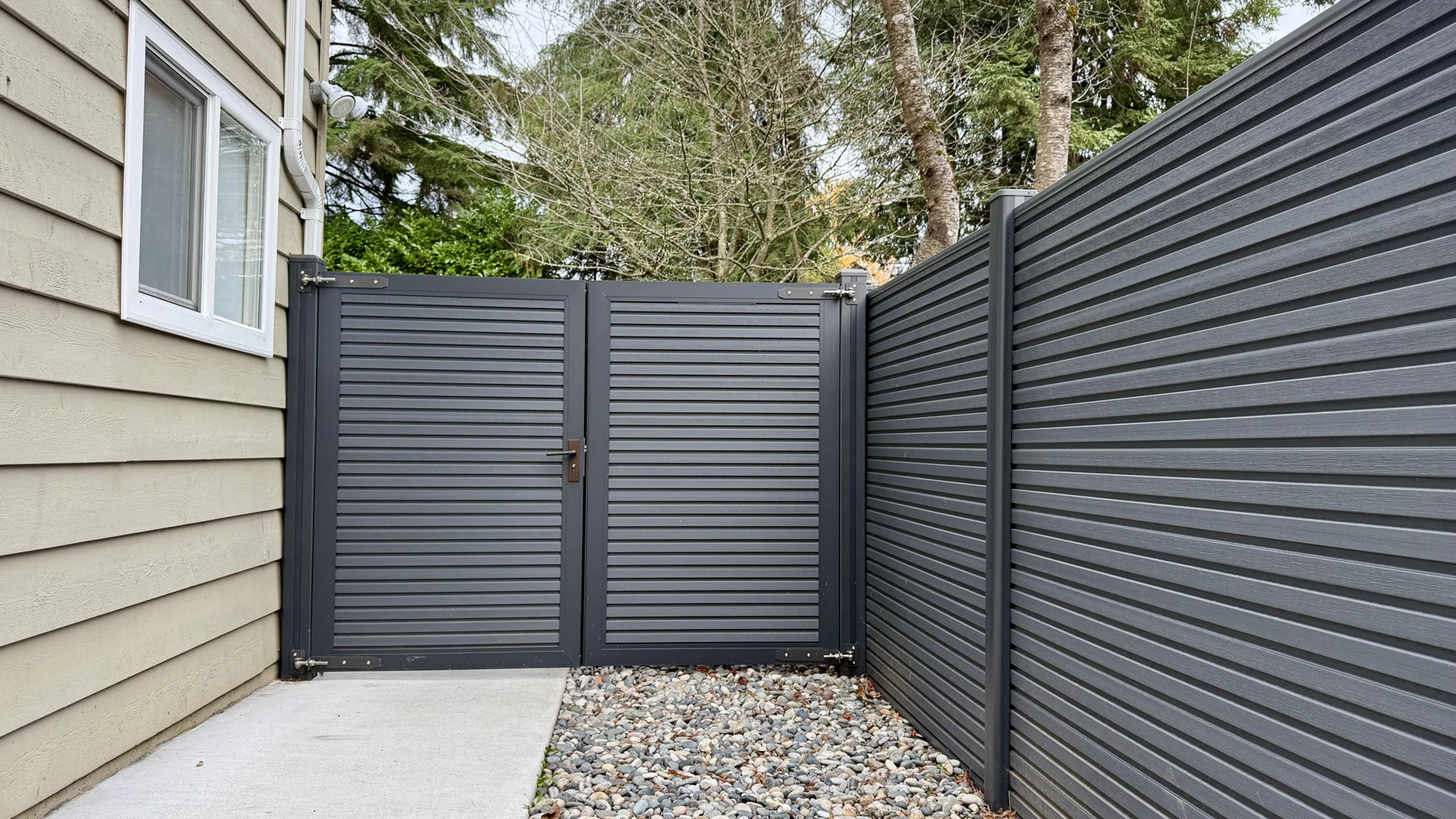 Two NeoLine slatted composite gate leaves beside matching fencing at Kilmarnock